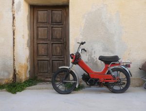 old motorcycle scooter parked in front of building 2023 11 27 04 57 39 utc
